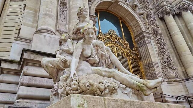 Stone sculpture group, Petit Palais entrance, Paris in France. Low-angle pov
