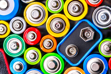Energy abstract background of colorful batteries.Old used batteries ready for recycling.Used...