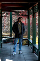 Caucasian man explores traditional Chinese architecture in vibrant Chinatown