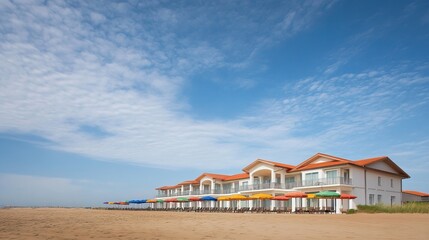 Beachfront hotel with rows of umbrellas lined up in the sand