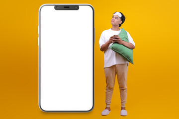 Young Asian Man Looking Aside to Smartphone Blank Screen for Mockup