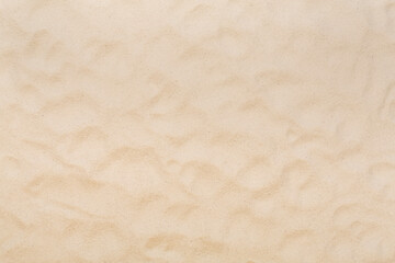 Textured beach sand as background, top view