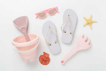 Children's flip flops and beach toys on color background,,top view