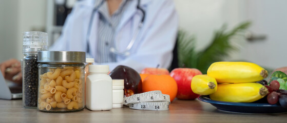 Nutrition and Dietary Consultation. A healthcare professional showcasing a variety of foods and supplements during a patient consultation.