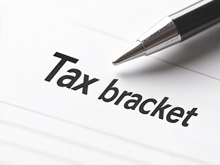Tax bracket document with pen, indicating financial planning and taxation cpa business website and advertisement 