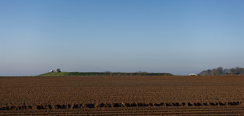 A Tractor and Trailer seen on top of a fenced off Embankment at Hatton Farm near to East Haven with...
