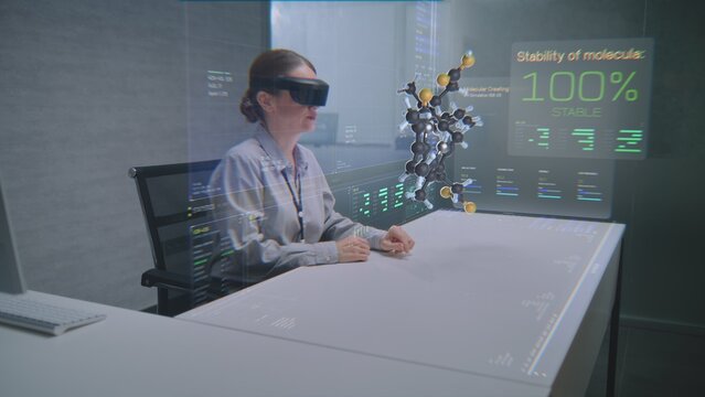 Female Professional Uses Augmented Reality Headset to Visualize 3D Hologram of Molecular Compounds in Advanced Office. Virtual Visualization of Artificial Intelligence Based Software Interface.