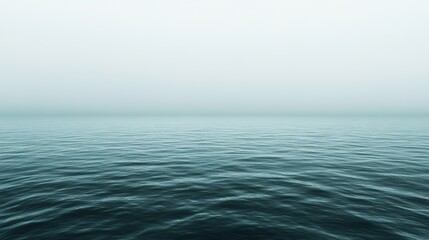 Fototapeta premium Serene ocean horizon under a misty sky creating a tranquil and peaceful scene with calming blue water and soft light for background