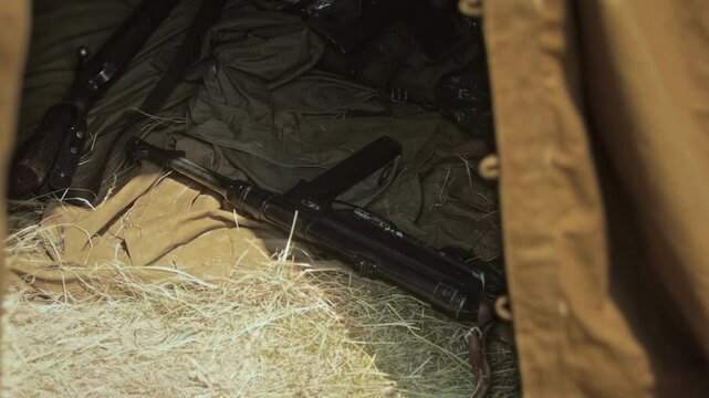 WWII German MP40 Submachine Gun and Karabiner 98k rifle Lie on Ground Sheet in Soldier Tent before battle show of second world war. Historical reenactment. Military equipment