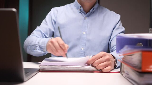 Office worker crumping paper in frustration at desk