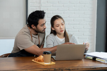 Lifestyle small business couple happy working together in cafe coffee shop, cheerful wife talking...