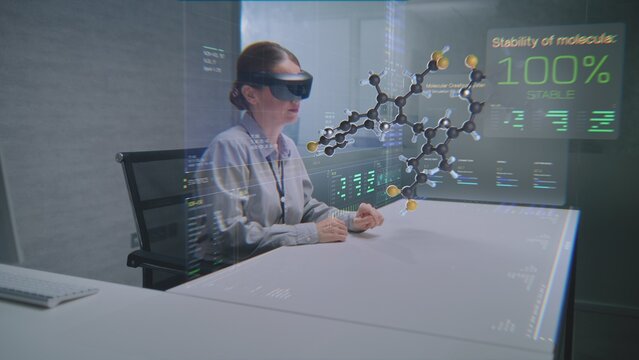 Female Professional Uses Augmented Reality Headset to Visualize 3D Hologram of Molecular Compounds in Advanced Office. Virtual Visualization of Artificial Intelligence Based Software Interface.
