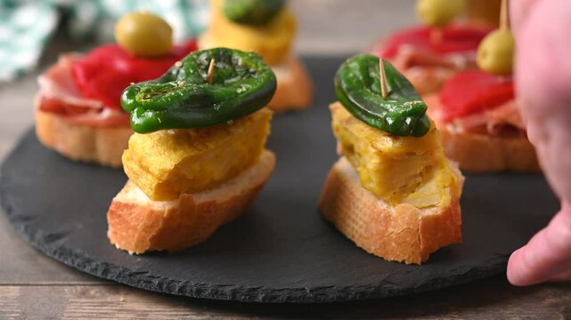 Traditional Spanish pintxos on wooden table