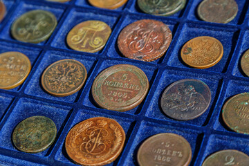 Numismatics.Old coins Russian Empire copper 18-19 century.Collection of ancient coins of the Russian Empire on a blue background.Antikvariat.