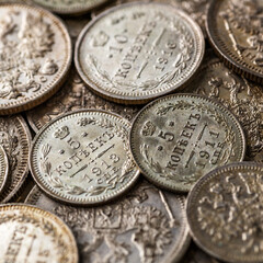 Gold and silver coins of the Russian Empire19 - 20 century in the background kopyur.Five rubles Nicholas II.Concept Russian antiques.Antikvariat.
