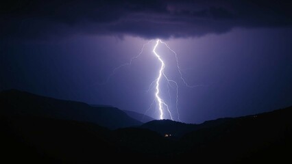 Lightning in the night over mountains