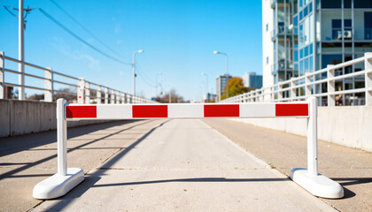Barrier Blocking Access on Urban Road Under Clear Blue Sky  