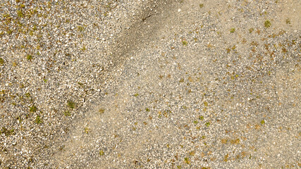 Aerial view perpendicular to rugged terrain with pebbles. ideal for texture, pattern and background