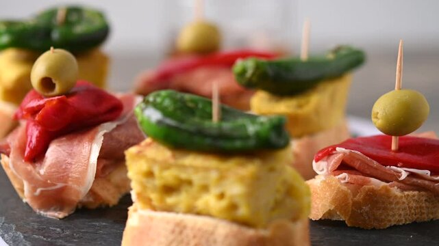 Traditional Spanish pintxos on wooden table