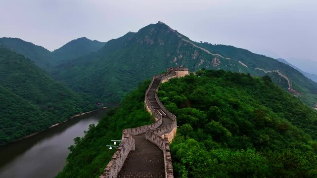 Drone flying backwards along the Great Wall of China, summer day in Beijing