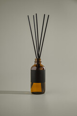 Glass bottle for aroma diffuser in minimalist advertising style. Mockup for lettering with empty label.