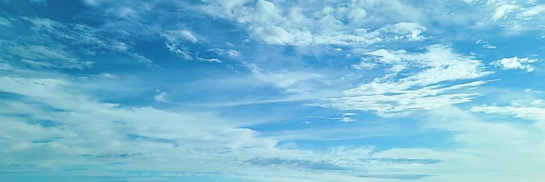 Cloudscape, Timelapse of Clear Blue Sky with Soft Wispy White Clouds, for wide background, with a serene and tranquil feel