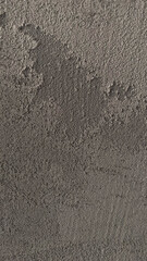 Close-up of a rough, gray concrete wall texture.
