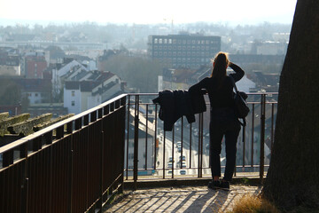 Young woman overlooks the morning cityscape