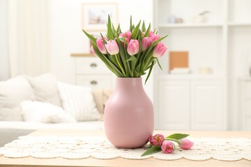Bouquet of beautiful tulips in vase on table indoors