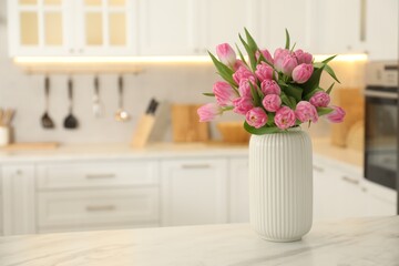 Bouquet of beautiful tulips in vase on white marble table indoors, space for text