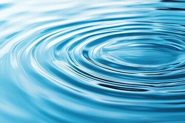 Calm blue water surface with concentric ripples emanating from a central point. reflecting serene natural beauty. ideal for relaxation or meditation themes