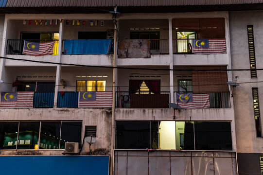 Malaysian flags hanging from apartment balconies at night, Kuala Lumpur, Malaysia