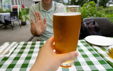 Reject a glass of beer, man refusing alcohol, stop drinking, sobriety concept, saying no to beer...
