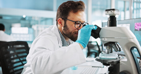 Scientist, man and medical study with microscope at lab with sample, review and glasses for pharma...