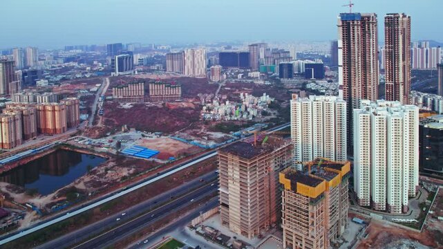 crane construction buildings with Prestige Beverly Hills and ORR at financial district, Nanakramguda, hyderabad, india. day time, push in, drone shot, 4k.