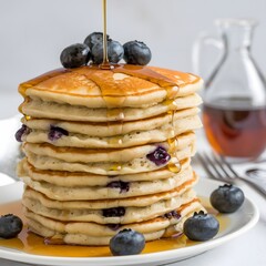 Close-up of a stack of warm, fluffy pancakes covered with maple syrup, isolated against white – pancakes wallpaper – bakery wallpaper – breakfast wallpaper – pancakes image

