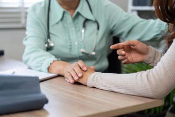 Patient Engagement and Trust. A healthcare professional holding a patient's hand to build rapport...