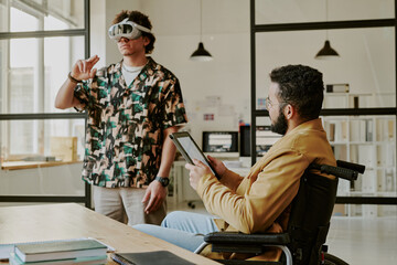 Medium shot of male talented and highly skilled gamedevs testing new project together in office,...