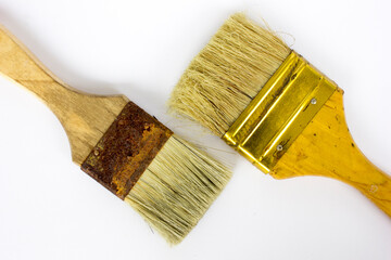 Still life of two old decorating paint brushes, isolated on white background.