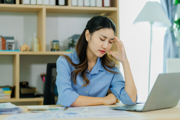 A young office woman appears frustrated as she struggles to reconcile the mismatched figures in the...