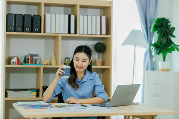 A female staff member pauses from work to sip her coffee and recharge.