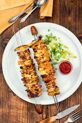 Bacon and fried potatoes on wooden surface, BBQ.
