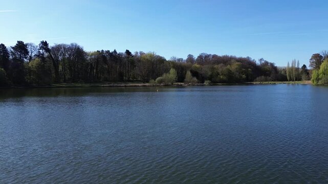 Drone view of a beautiful park and water pond in Brussels in a calm spring morning low vantage point