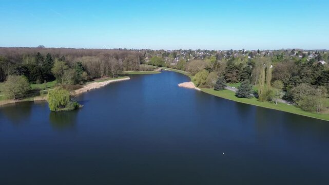 Drone view of a beautiful park and water pond in Brussels in a calm spring maring