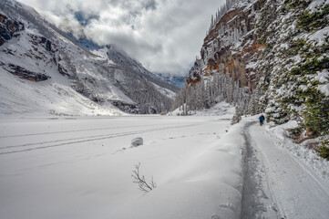Hiking trail beside frozen Lake Louise in Banff National Park, Alberta, Canada