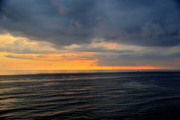 Fototapeta premium Bird's eye view of the sea at sunset before a thunderstorm.