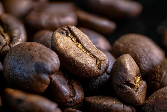 Close-up of roasted coffee beans in warm lighting.