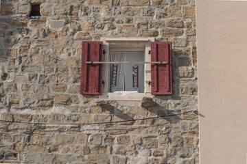 Rustic Window with Red Shutters in Piran, Slovenia