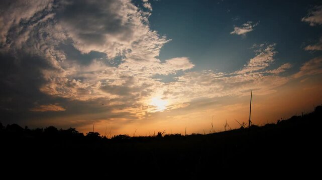 Sunset Over Silhouette of Rice Field