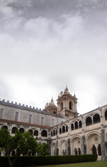 Obraz premium Interior hall of the Portuguese monastery in the city of Alcobaça, sky with clouds and rain falling in motion blur, bell tower, religion